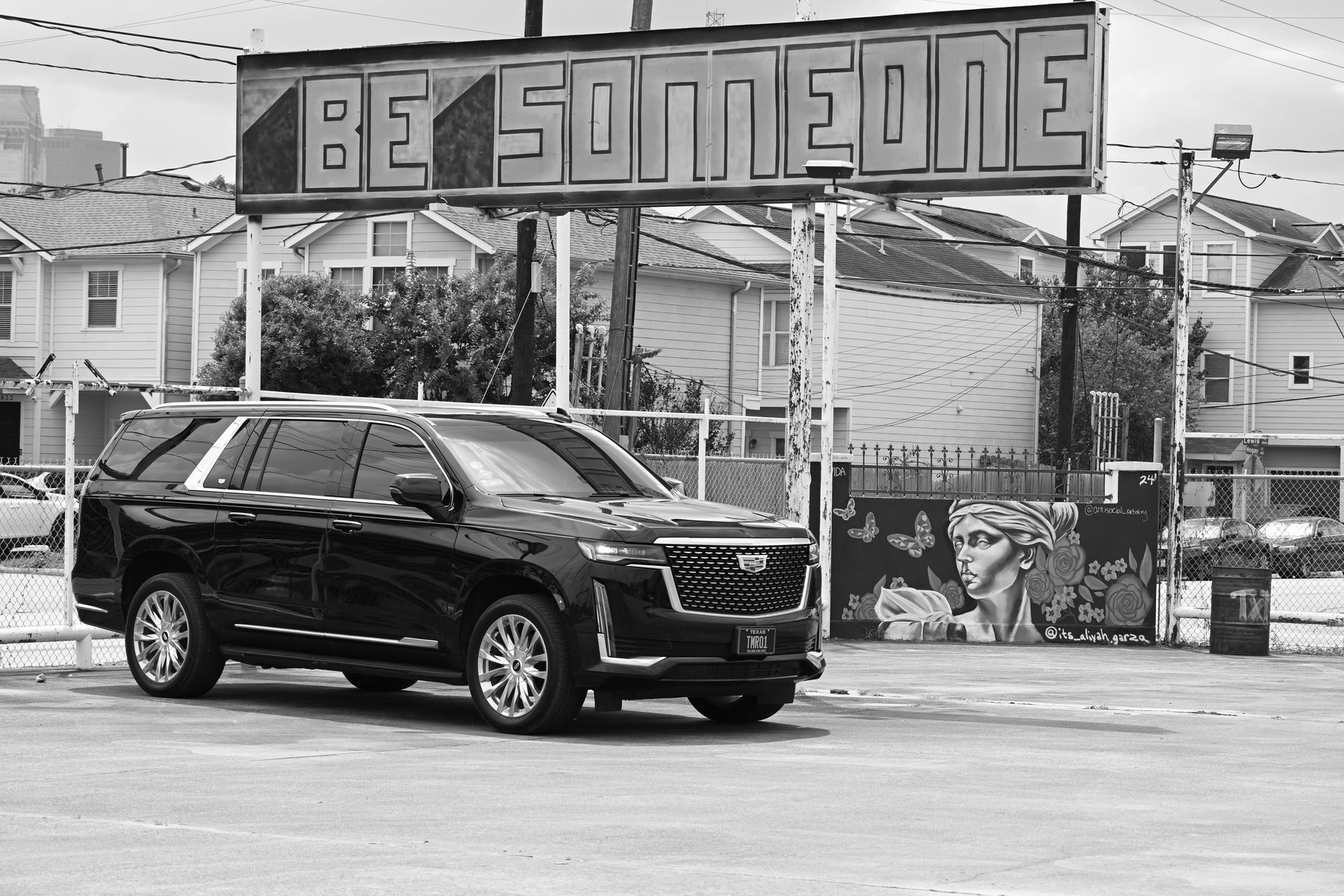 TMR Escalade at the Be Someone sign in Houston